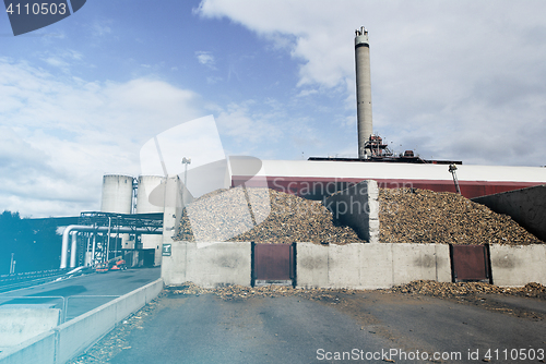 Image of bio power plant with storage of wooden fuel (biomass) against bl