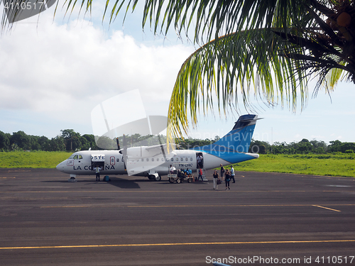 Image of editorial tourist leaving plane Corn Island Airport Nicaragua