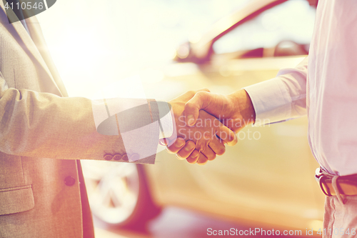 Image of close up of male handshake in auto show or salon