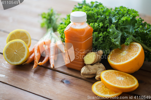 Image of bottle with carrot juice, fruits and vegetables