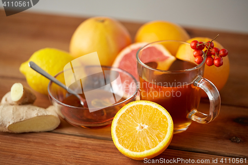 Image of tea with honey, lemon and ginger on wood