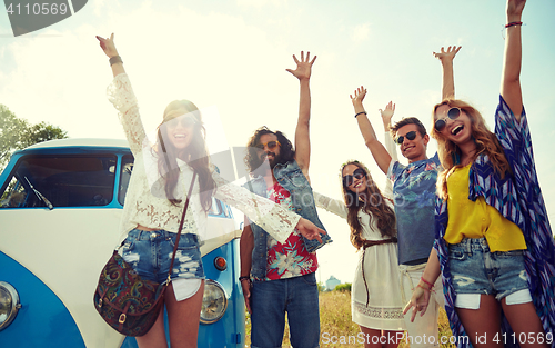 Image of smiling hippie friends having fun over minivan car