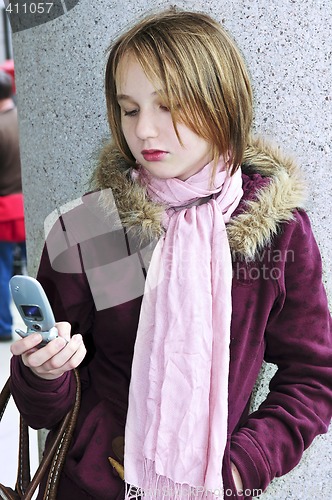Image of Teenage girl text messaging on cell phone