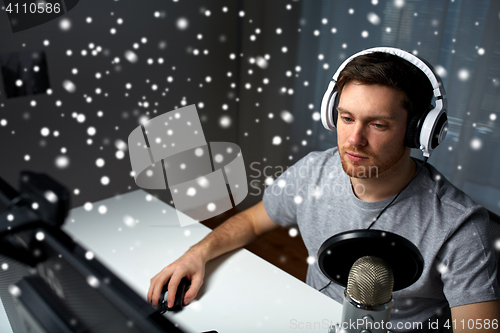 Image of man in headset playing computer video game at home