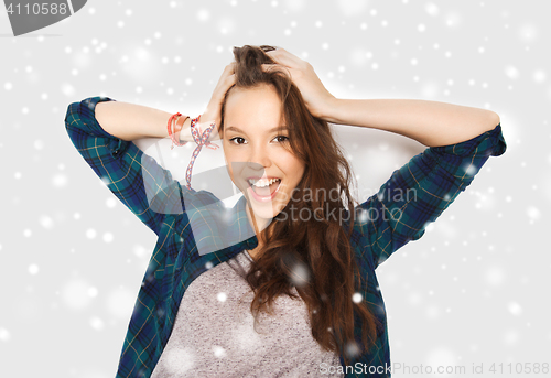 Image of happy smiling pretty teenage girl over snow