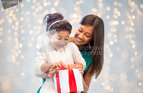 Image of happy mother and child girl with gift box