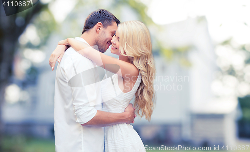 Image of happy couple hugging over summer house background