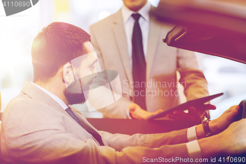 Image of happy man with car dealer in auto show or salon