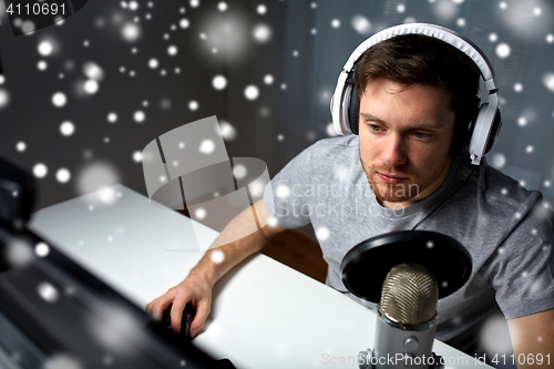 Image of man in headset playing computer video game at home