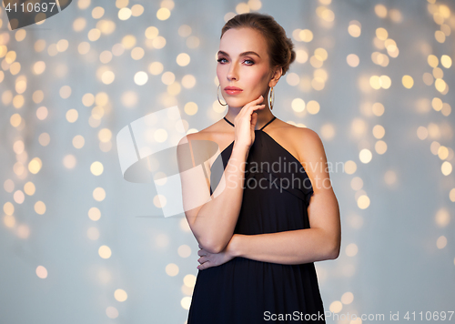 Image of beautiful woman in black wearing diamond jewelry