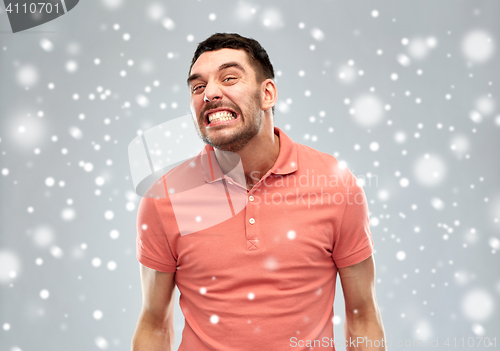 Image of angry man over snow