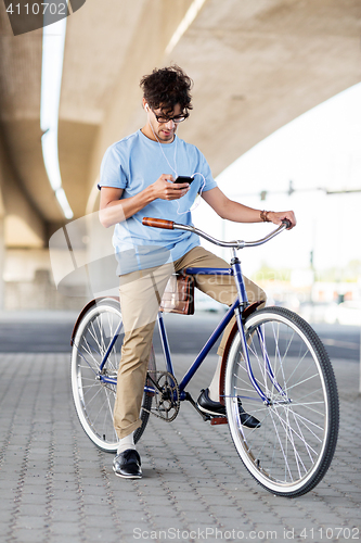 Image of man with smartphone and earphones on bicycle