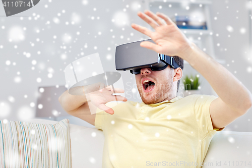 Image of young man in virtual reality headset or 3d glasses