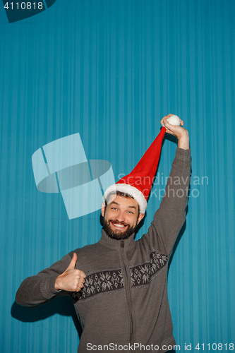 Image of Smiling christmas man wearing a santa hat