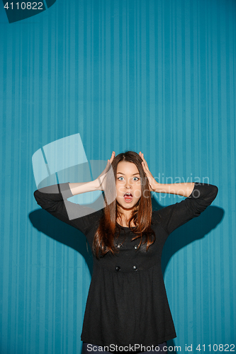 Image of Portrait of young woman with shocked facial expression