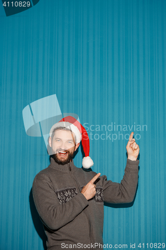 Image of Smiling christmas man wearing a santa hat