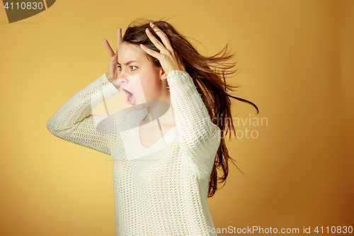 Image of Portrait of young woman with shocked facial expression