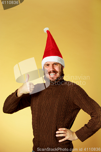 Image of Smiling christmas man wearing a santa hat