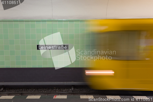 Image of Yellow subway train in motion on Berlin Alexanderplatz underground station.