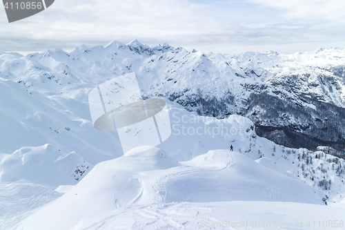 Image of Freeride snowboarder on the top of the mountain.