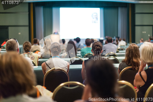 Image of Audience in lecture hall participating at business conference.