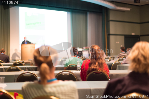 Image of Audience in lecture hall participating at business conference.