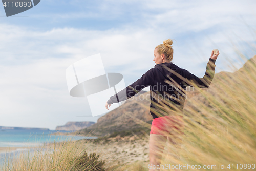 Image of Free Happy Woman Enjoying Last Autumn Sun on Vacations.