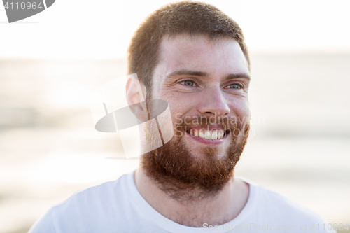 Image of face of happy smiling young man outdoors