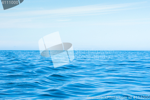 Image of Wavy blue ocean with blue sky