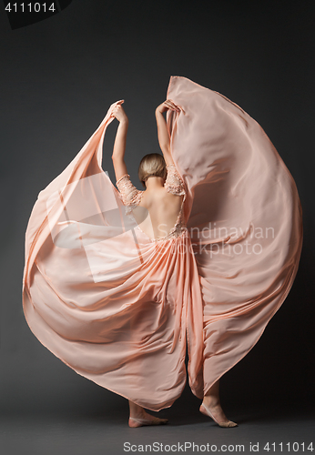 Image of Woman dancing in light dress