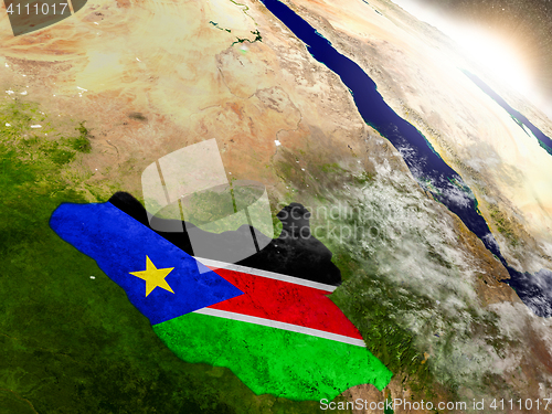 Image of South Sudan with flag in rising sun
