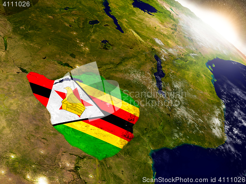 Image of Zimbabwe with flag in rising sun