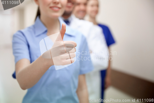 Image of close up of doctors at hospital showing thumbs