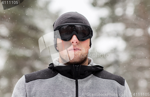 Image of sports man with ski goggles in winter outdoors