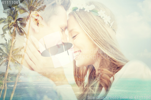 Image of happy smiling young hippie couple over beach