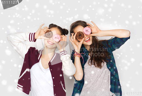 Image of happy pretty teenage girls with donuts having fun