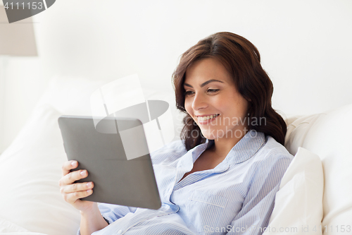 Image of happy pregnant woman with tablet pc at home