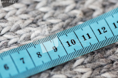 Image of close up of knitted item with measuring tape