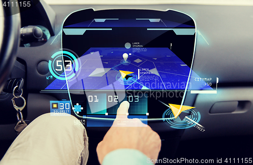 Image of close up of man with gps navigator on car computer