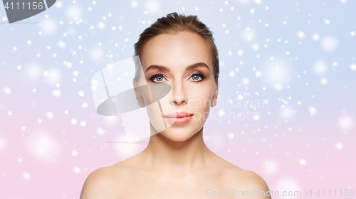 Image of beautiful young woman face over snow