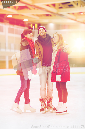 Image of happy friends taking selfie on skating rink