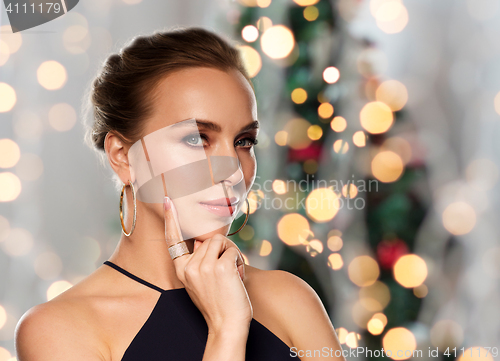 Image of beautiful woman in black wearing diamond jewelry