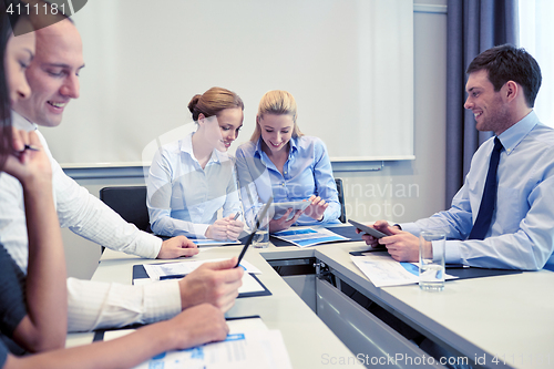 Image of smiling business people meeting in office