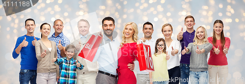 Image of happy people with shopping bags showing thumbs up