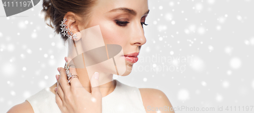 Image of close up of woman in white with diamond jewelry