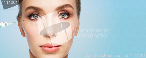 Image of woman face and syringe making injection