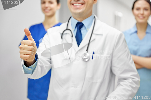 Image of close up of doctors at hospital showing thumbs