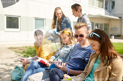 Image of group of students with notebooks at school yard