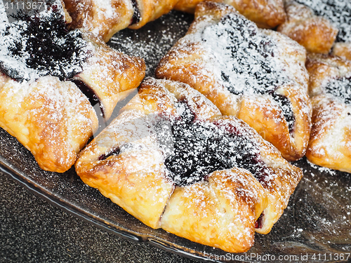 Image of Danish pastry with blueberry jam filling with white powdered sug