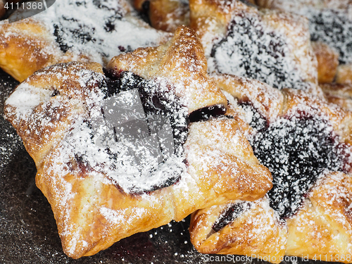 Image of Danish pastry with blueberry jam filling with white powdered sug